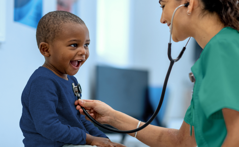 boy with nurse using stethoscope